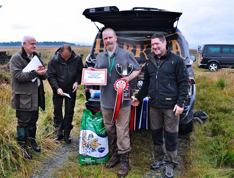 
 Paul Wilson presented with the Harrigoss Trophy by Ewen Steel of Harkila, judges Iain Marshalsay and Andy Cullen MBE looking on